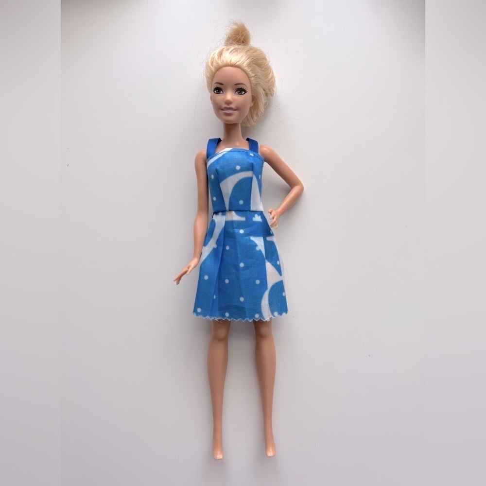 2015 Mattel Barbie doll with blonde hair and blue eyes, wearing a blue dress
